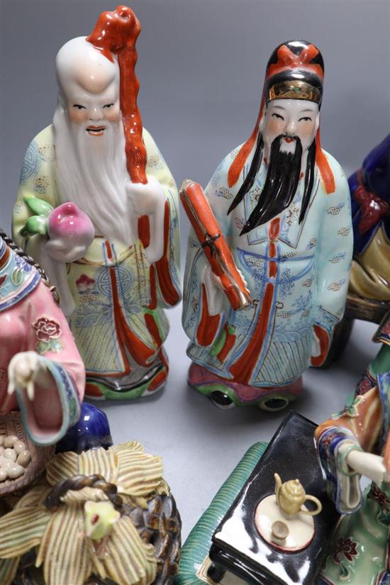 Three Chinese enamelled porcelain figures of immortals, tallest 24cm, three Shiwan type pottery groups, an agate necklace and a carving